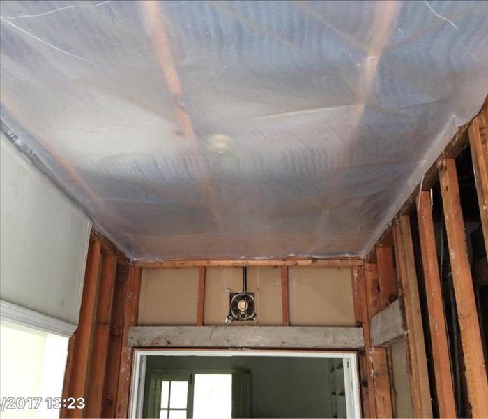 polyethelyne covering ceiling and some walls removed showing studs