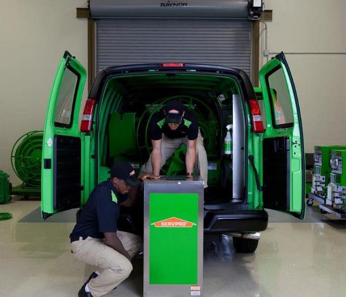 SERVPRO technicians unloading mold damage remediation equipment from a van
